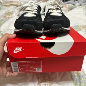 Nike size 5 youth sneakers black with white check.